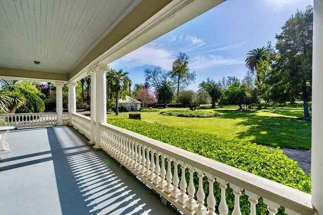 a view of a balcony with yard