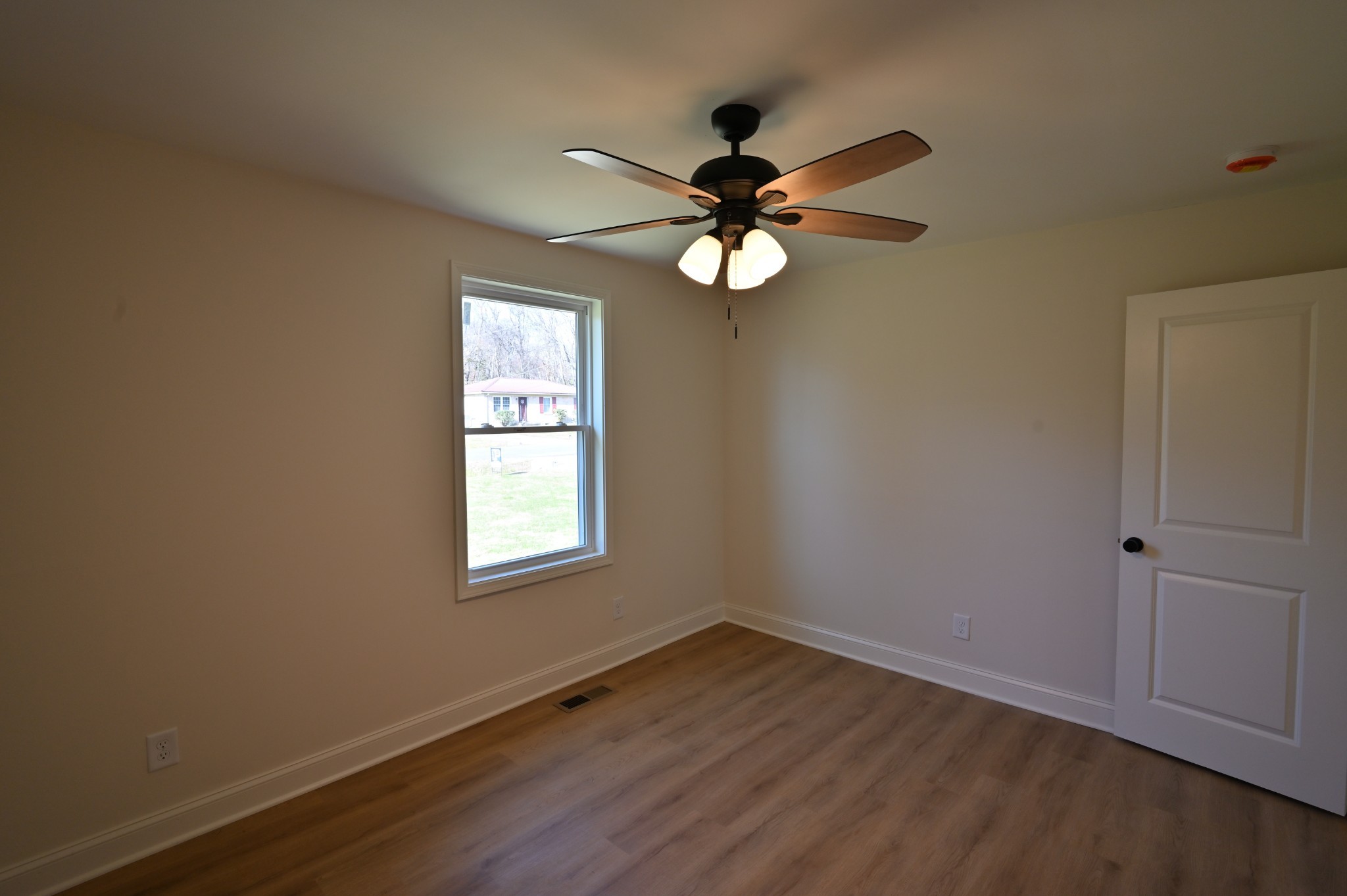 808 Hughes Street Spring Hill, TN 37174 - Photo 13 of 24 an empty room with wooden floor fan and windows