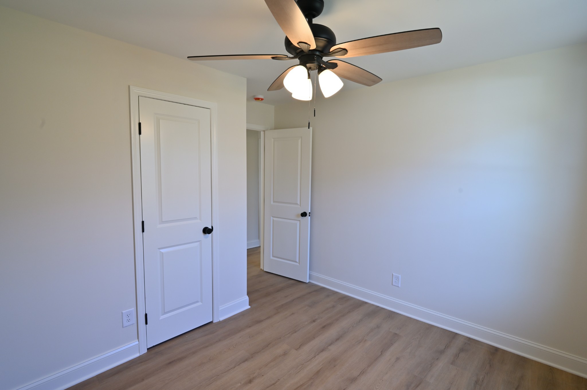 808 Hughes Street Spring Hill, TN 37174 - Photo 19 of 24 a view of an empty room with wooden floor