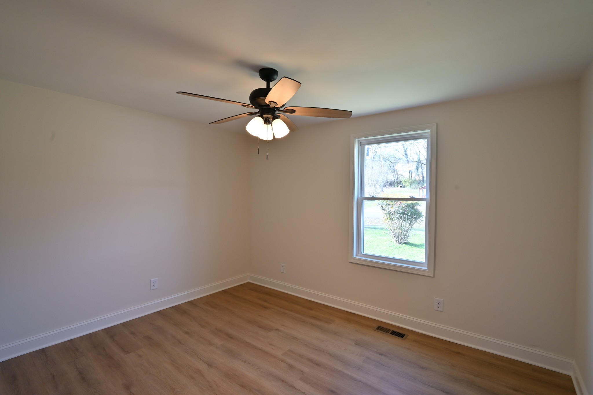 808 Hughes Street Spring Hill, TN 37174 - Photo 20 of 24 an empty room with wooden floor and windows
