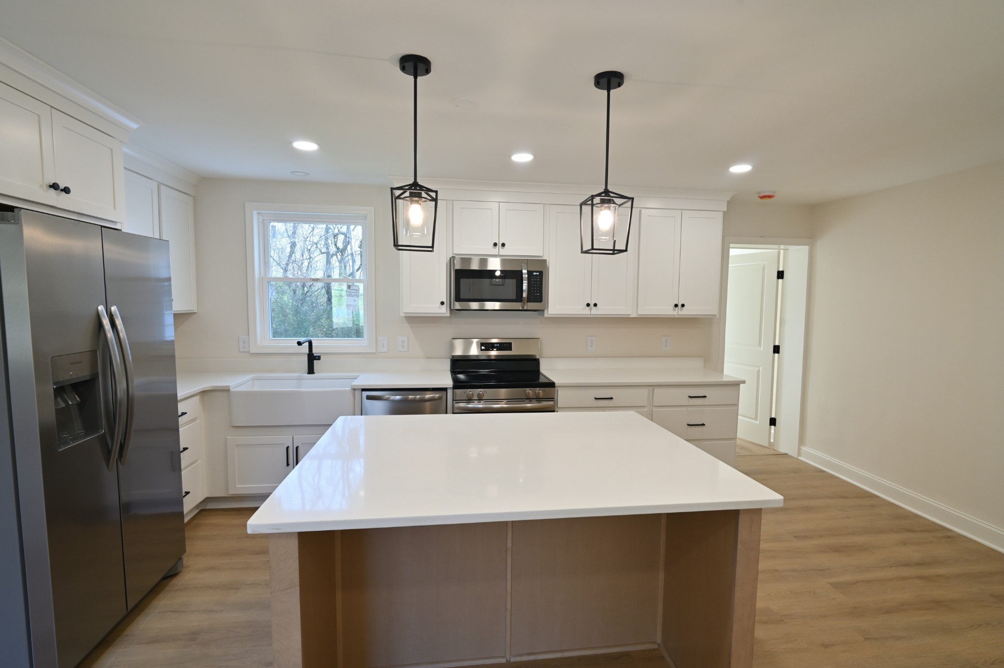 808 Hughes Street Spring Hill, TN 37174 - Photo 8 of 24 a kitchen with a appliances a sink cabinets and a wooden floor