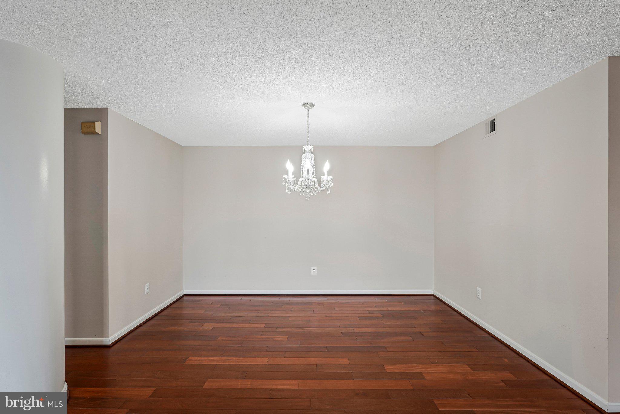 19385 Cypress Ridge Terrace, Unit 815 Leesburg, VA 20176 - Photo 11 of 35 a view of a room with wooden floor and a window