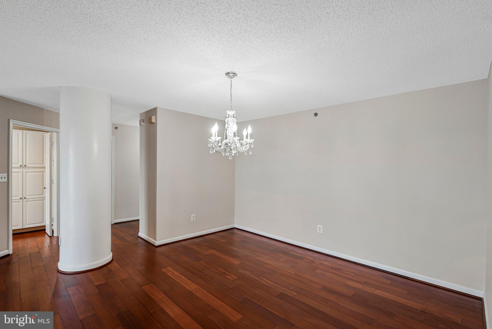 19385 Cypress Ridge Terrace, Unit 815 Leesburg, VA 20176 - Photo 12 of 35 a view of a room with wooden floor and chandelier