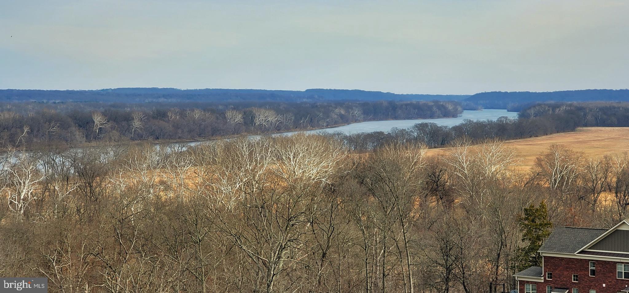 19385 Cypress Ridge Terrace, Unit 815 Leesburg, VA 20176 - Photo 2 of 35 a view of a lake with mountains in the background