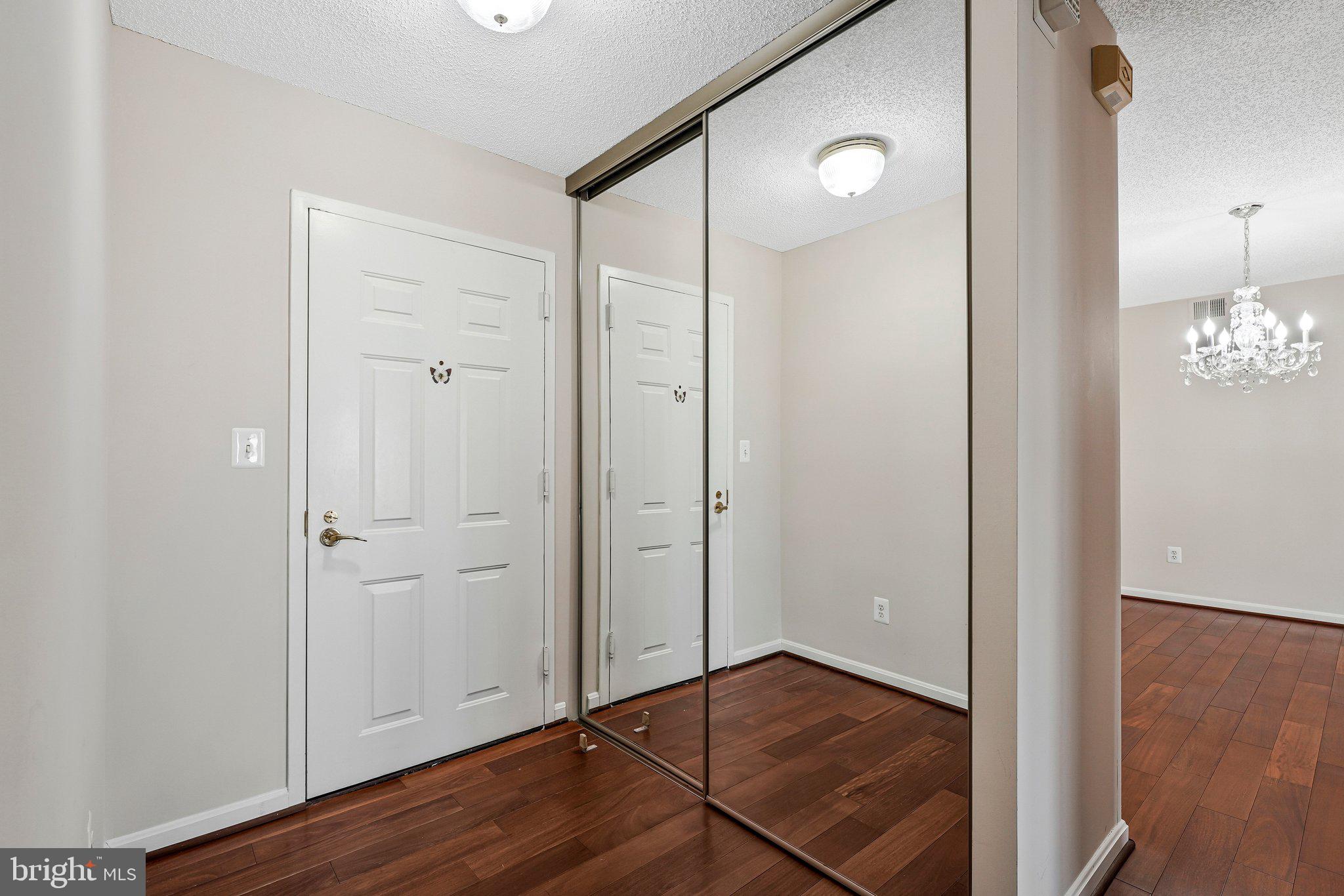 19385 Cypress Ridge Terrace, Unit 815 Leesburg, VA 20176 - Photo 4 of 35 an empty room with wooden floor and windows