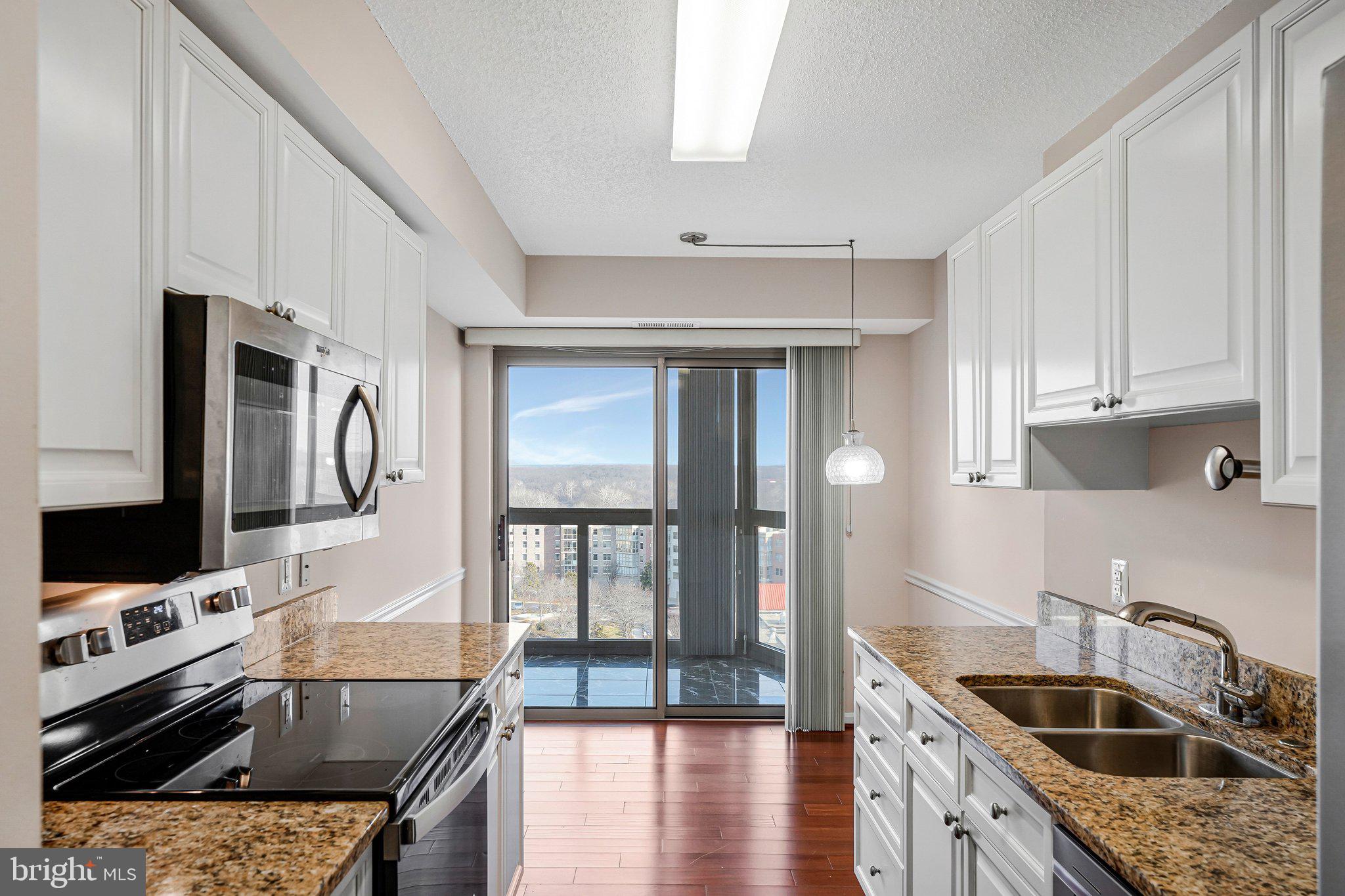19385 Cypress Ridge Terrace, Unit 815 Leesburg, VA 20176 - Photo 7 of 35 a kitchen with stainless steel appliances granite countertop a sink stove and refrigerator