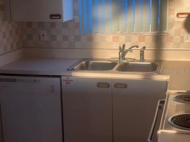 a close view of sink and washer dryer