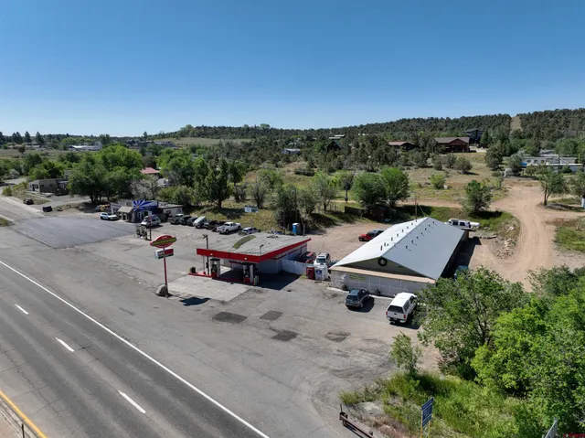 a view of a patio with table and chairs a barbeque and potted plants
