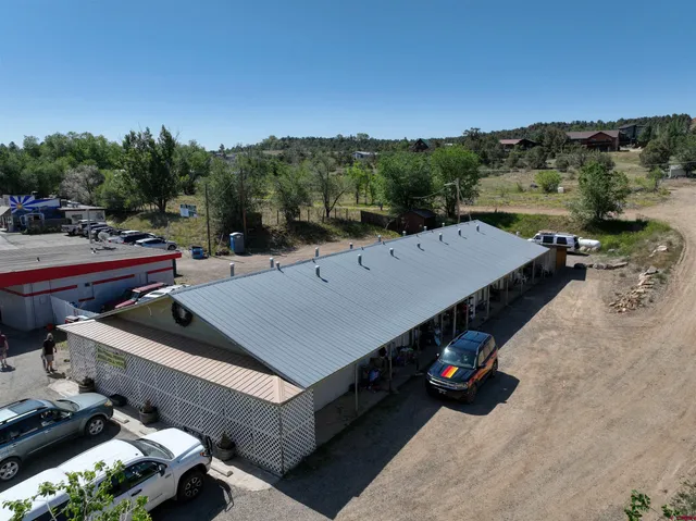 an aerial view of a house with a yard and lake view