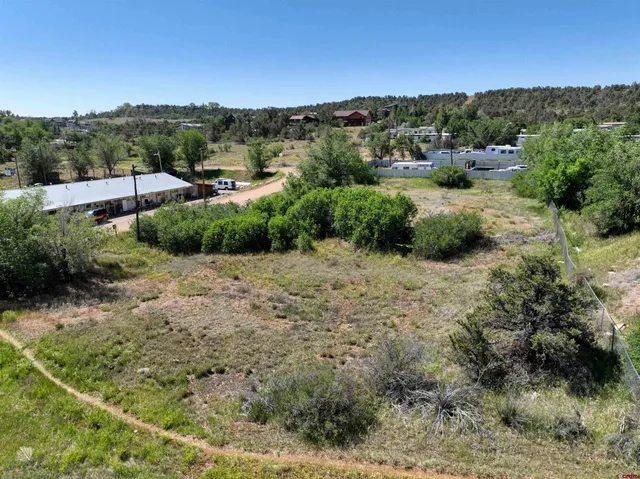 an aerial view of a house with a yard and lake view