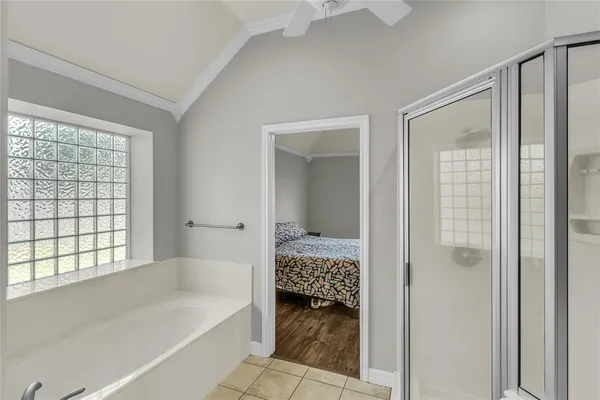 a bathroom with a tub shower and a sink