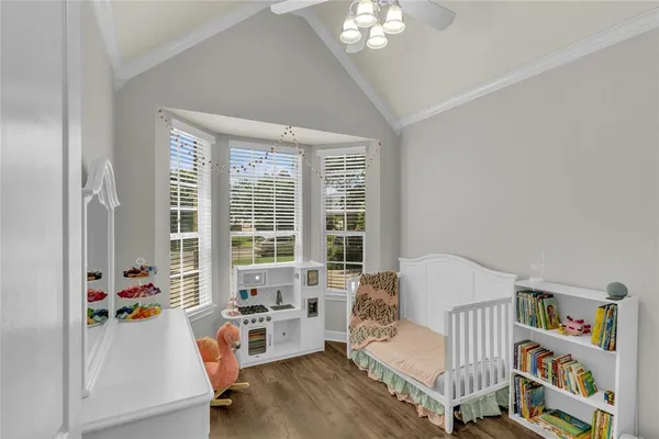 a bedroom with furniture and a large window