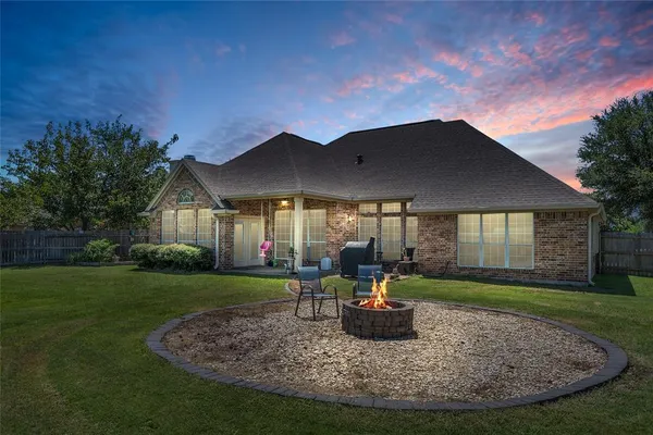 a view of a house with backyard porch and sitting area