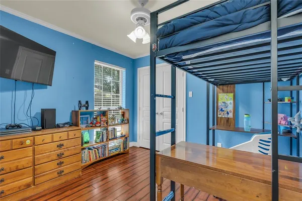 a view of a room with wooden floor and furniture