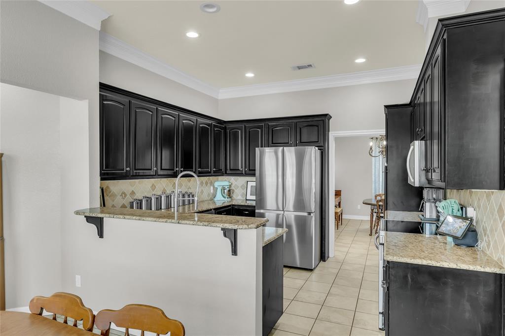 5613 Landsdown Drive Waco, TX 76708 - Photo 5 of 27 a kitchen with stainless steel appliances granite countertop a refrigerator and a sink