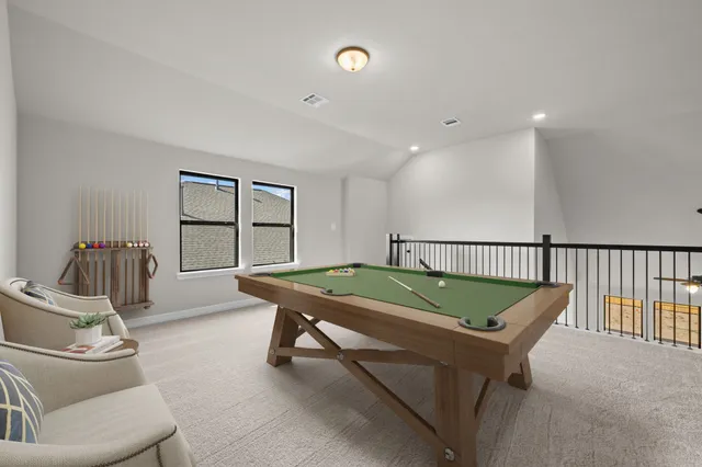 a room with furniture pool table and windows