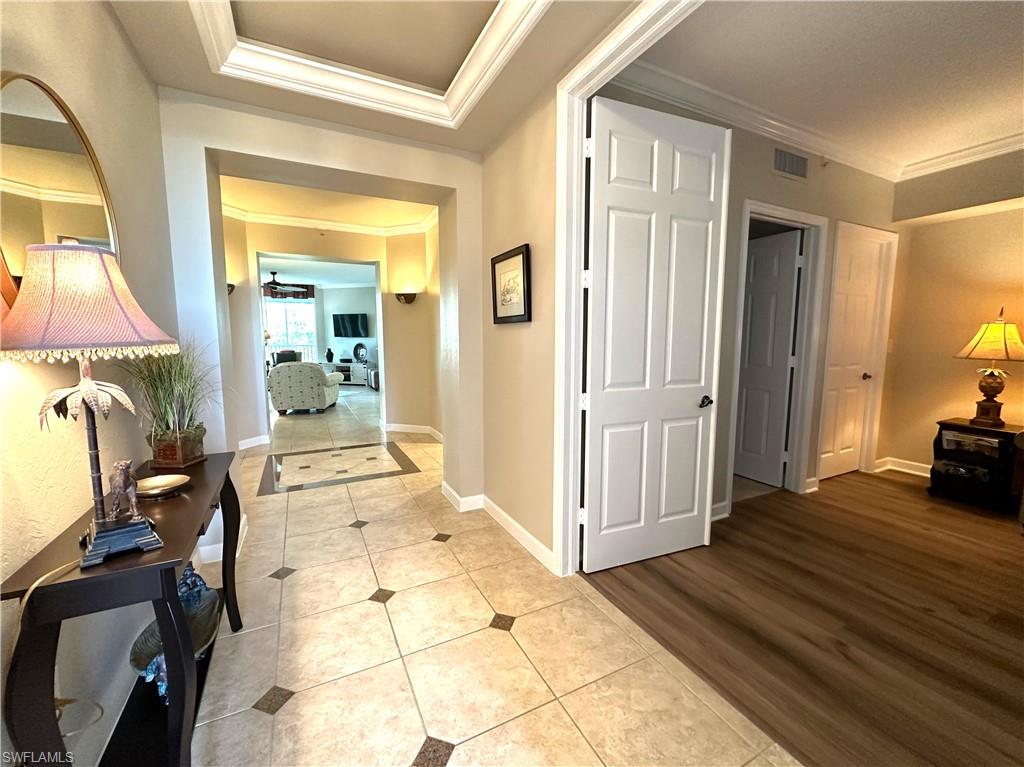 325 Dunes Boulevard, Unit 306 Naples, FL 34110 - Photo 2 of 40 a view of a bedroom with wooden floor and bedroom view