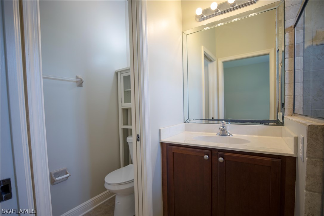 12722 River Road Fort Myers, FL 33905 - Photo 13 of 18 a bathroom with a sink toilet and mirror