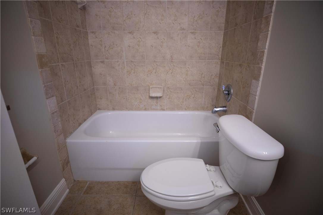 12722 River Road Fort Myers, FL 33905 - Photo 10 of 18 a white toilet sitting next to a bath tub