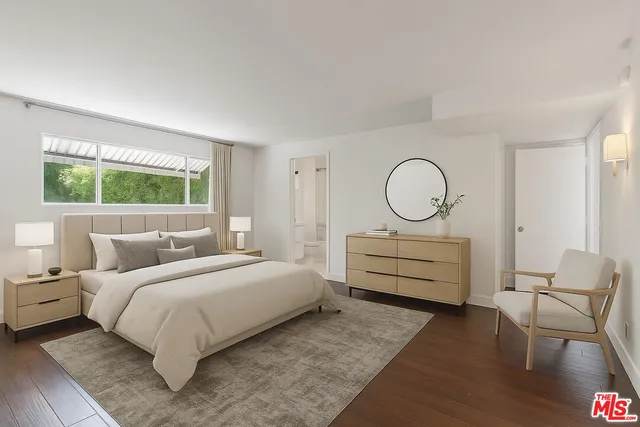 a bedroom with a bed a window and chair