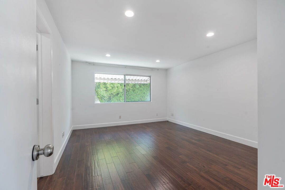 603 North Doheny Drive, Unit 2B Beverly Hills, CA 90210 - Photo 16 of 21 an empty room with wooden floor and windows