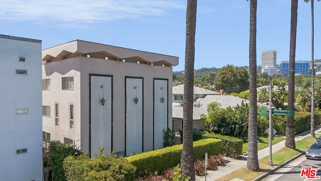 a front view of a house with a garden and plants