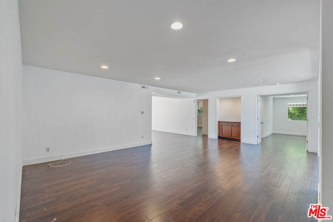 603 North Doheny Drive, Unit 2B Beverly Hills, CA 90210 - Photo 2 of 21 a view of an empty room with wooden floor and a window
