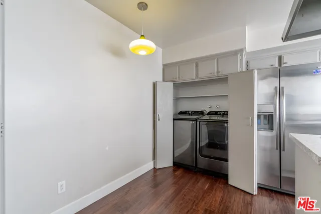 a kitchen with a refrigerator and a stove top oven