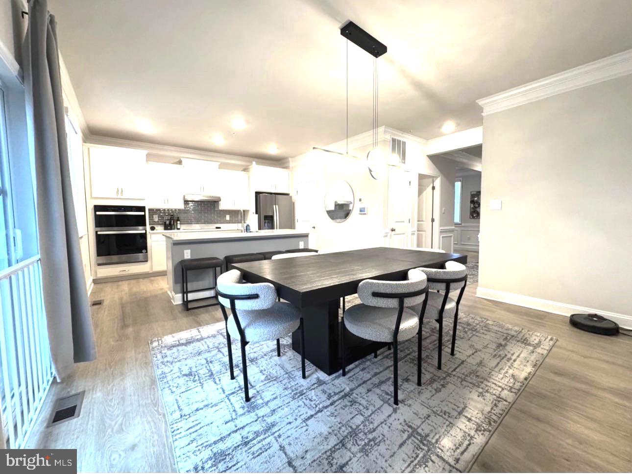 28 Buttercup Circle Elkton, MD 21921 - Photo 13 of 27 a dining room with a table chairs and a kitchen view