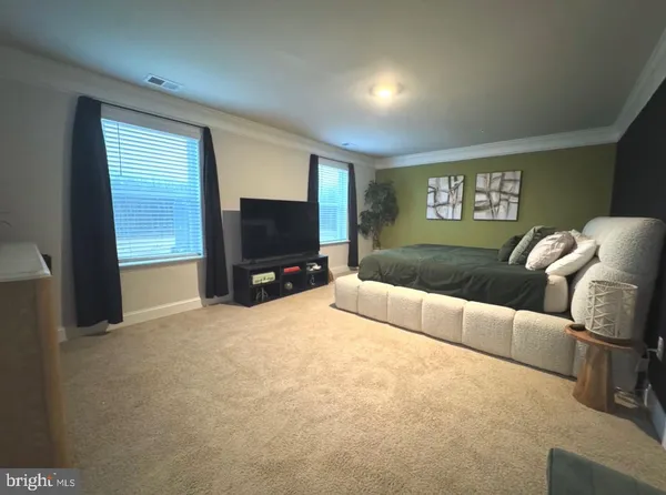 a bedroom with a bed and a couch