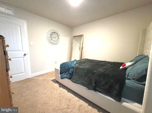 a bathroom with a sink and mirror with toilet