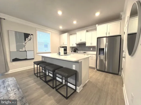 a kitchen with a sink appliances and cabinets
