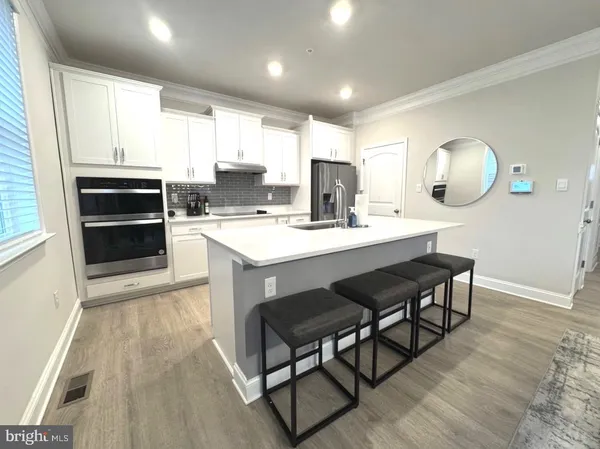 a kitchen with a sink stove and cabinets