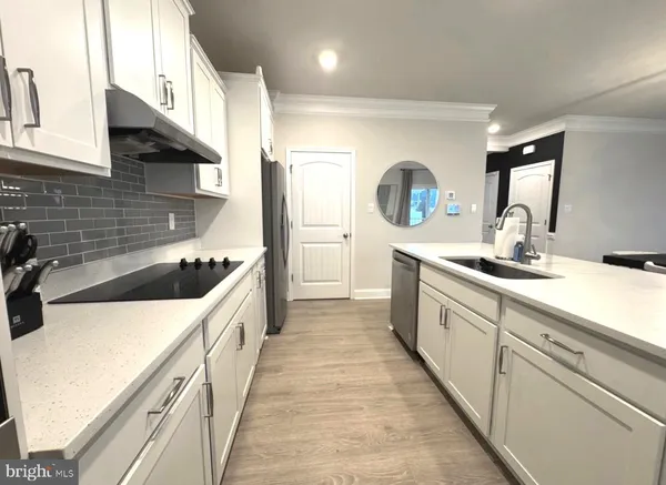 a kitchen with a sink and chairs