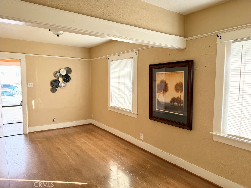 4451 Victoria Riverside, CA 92507 - Photo 3 of 17 an empty room with wooden floor and windows