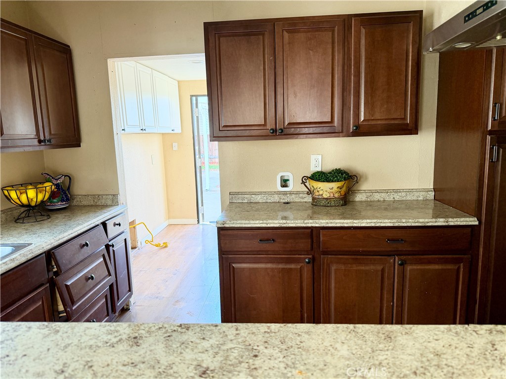 4451 Victoria Riverside, CA 92507 - Photo 6 of 17 a kitchen with stainless steel appliances granite countertop wooden cabinets sink and stove