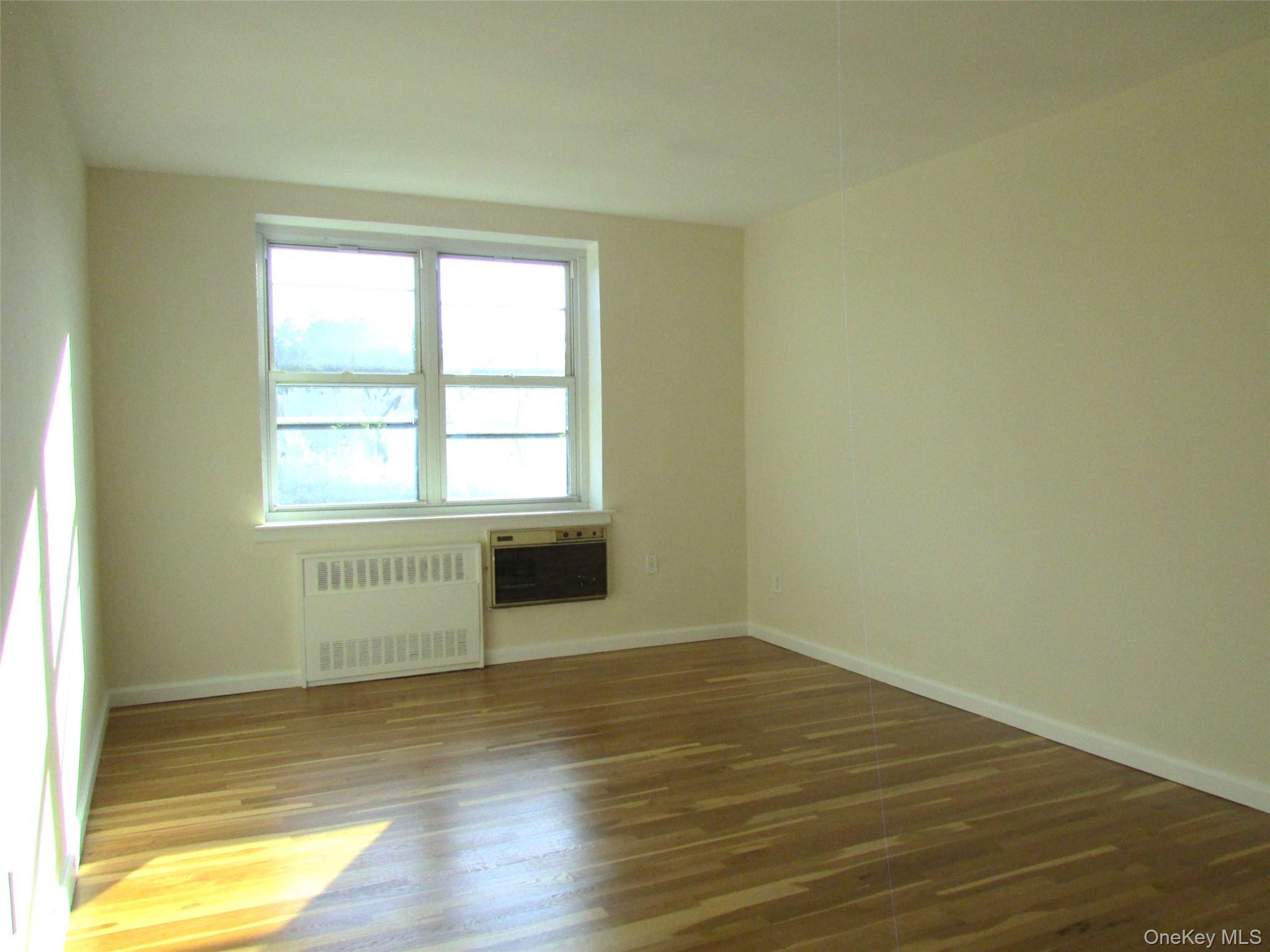 30 South Cole Avenue, Unit 6F Spring Valley, NY 10977 - Photo 13 of 30 a view of an empty room with wooden floor and a window