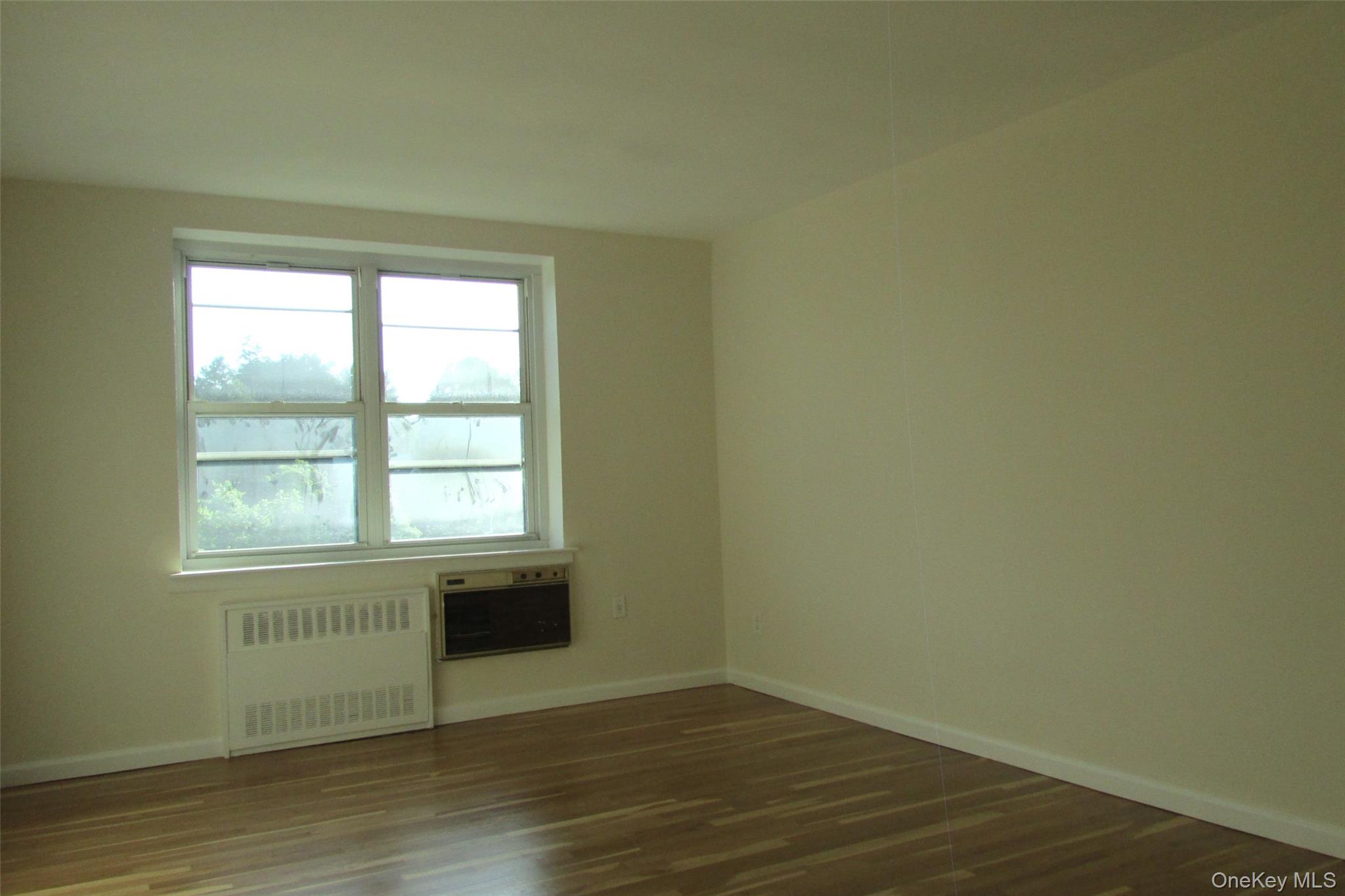 30 South Cole Avenue, Unit 6F Spring Valley, NY 10977 - Photo 14 of 30 an empty room with wooden floor and windows