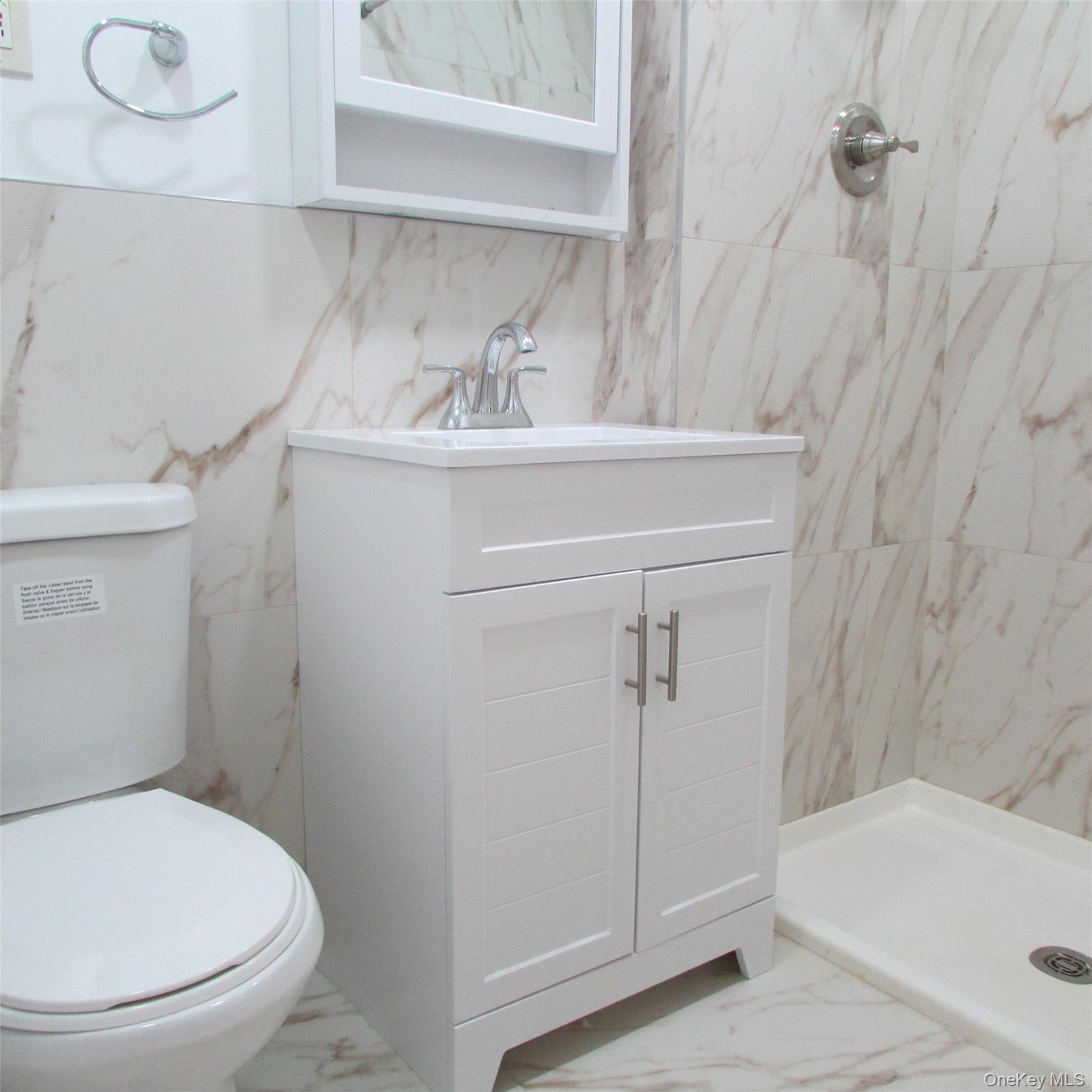 30 South Cole Avenue, Unit 6F Spring Valley, NY 10977 - Photo 16 of 30 a bathroom with a sink a toilet and shower