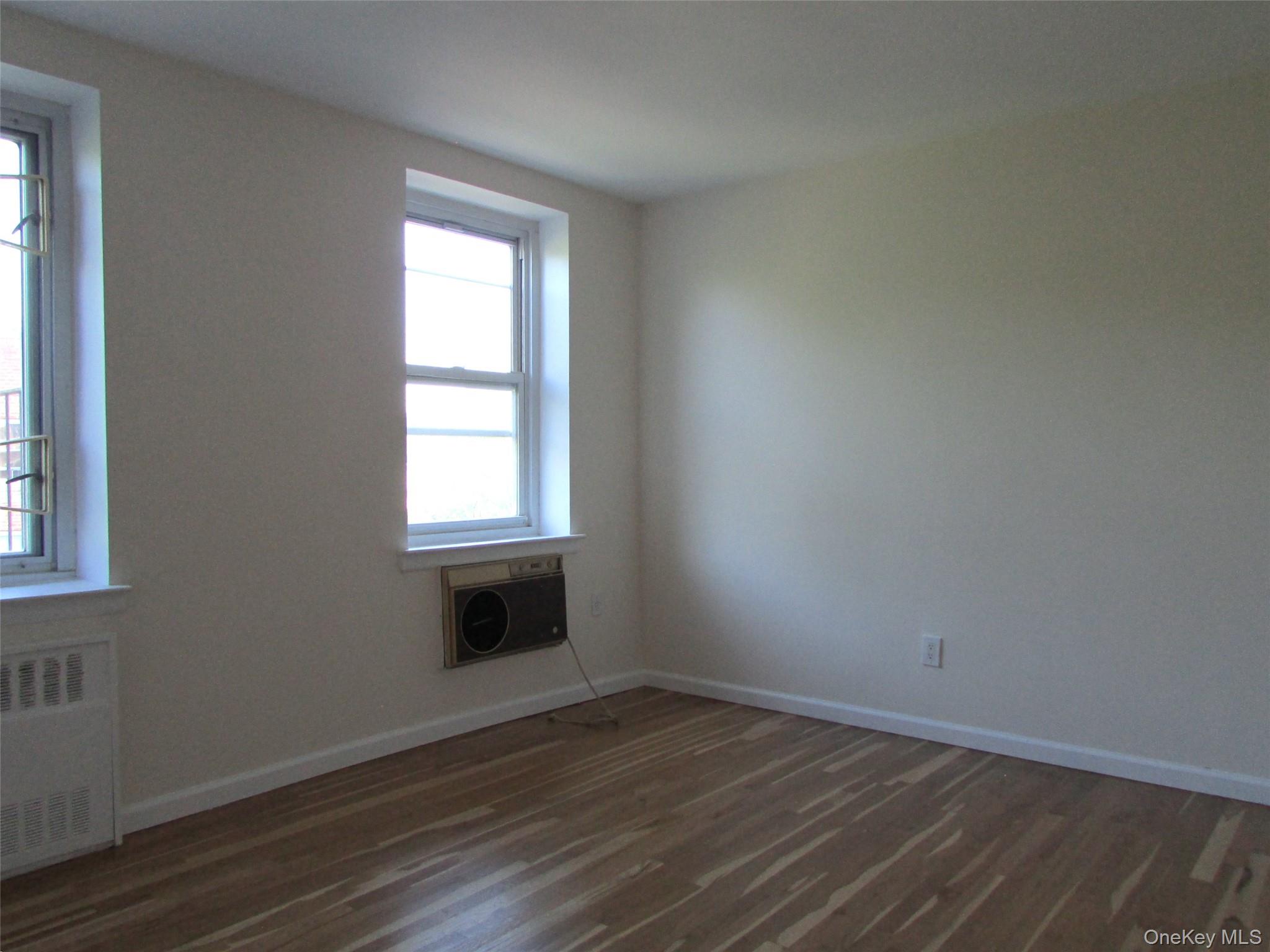 30 South Cole Avenue, Unit 6F Spring Valley, NY 10977 - Photo 17 of 30 an empty room with wooden floor and windows