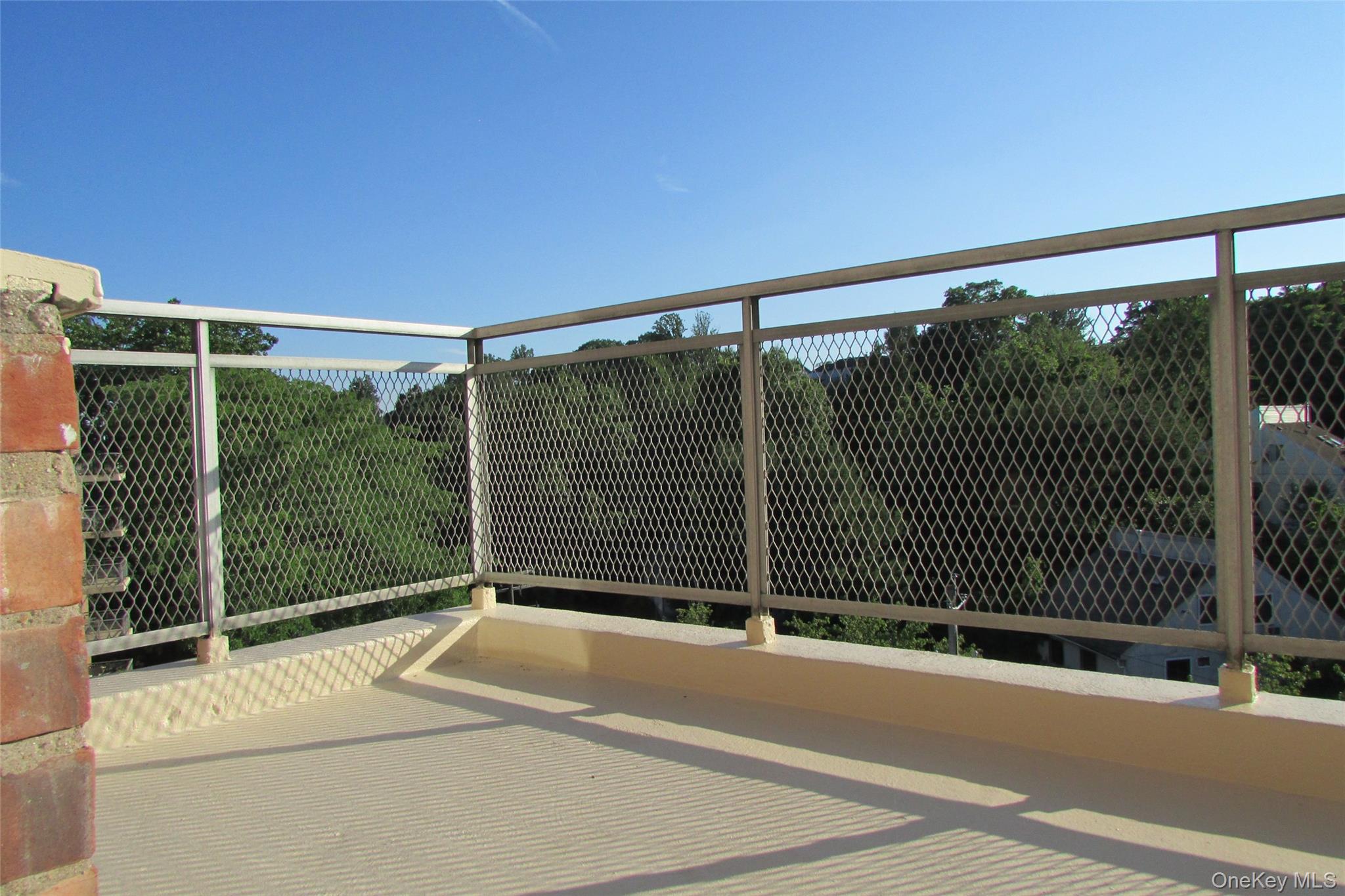 30 South Cole Avenue, Unit 6F Spring Valley, NY 10977 - Photo 24 of 30 a view of a building with a floor to ceiling window and wooden fence