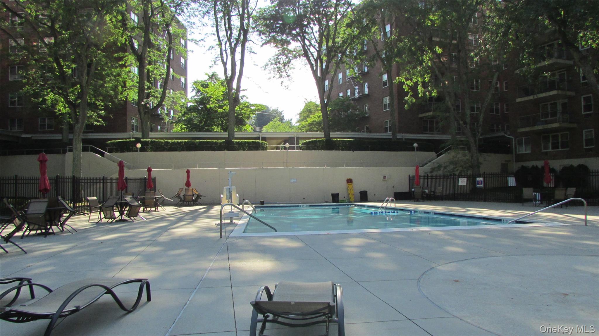 30 South Cole Avenue, Unit 6F Spring Valley, NY 10977 - Photo 27 of 30 a backyard of a house with table and chairs