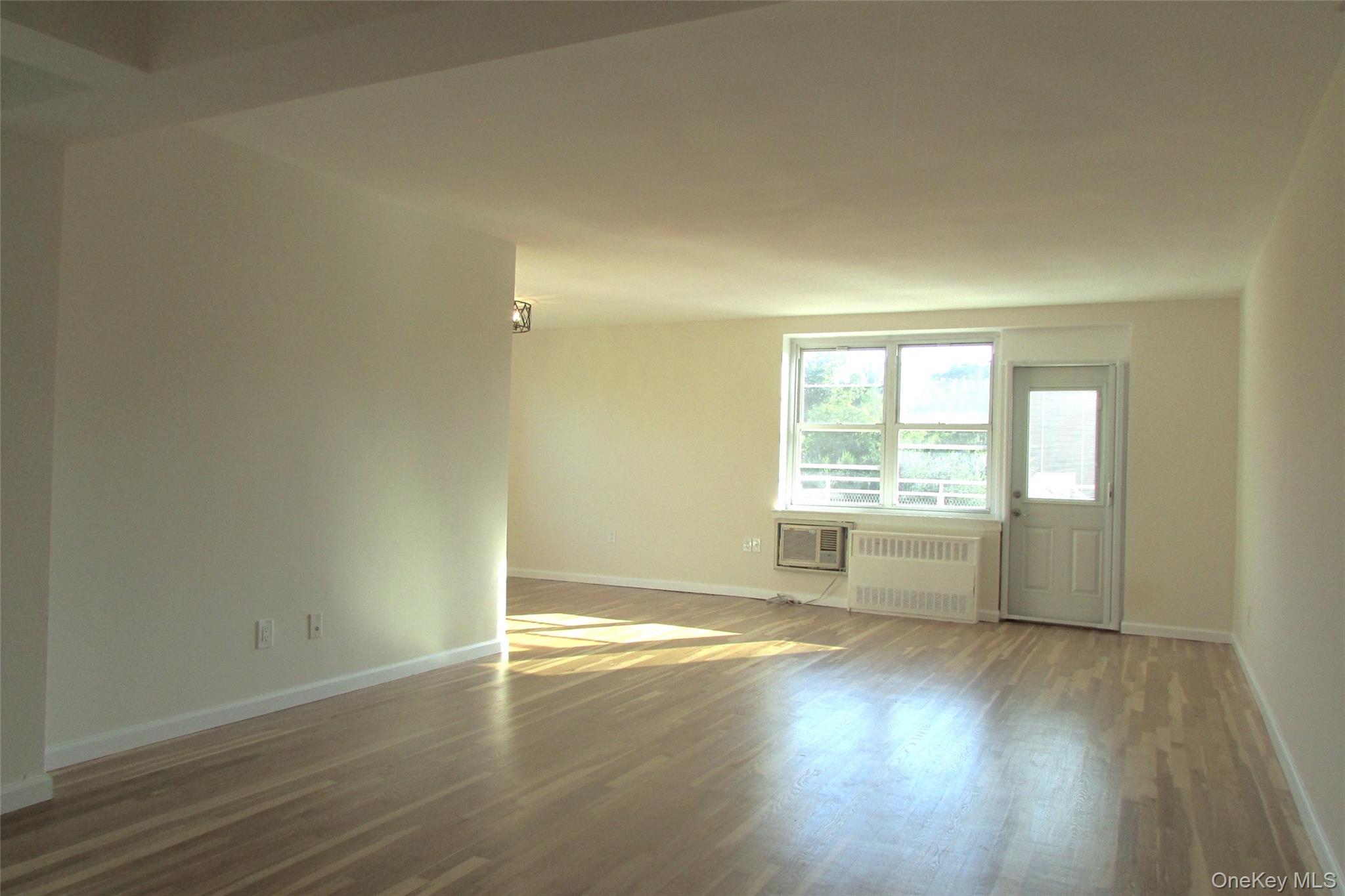 30 South Cole Avenue, Unit 6F Spring Valley, NY 10977 - Photo 4 of 30 an empty room with wooden floor and windows