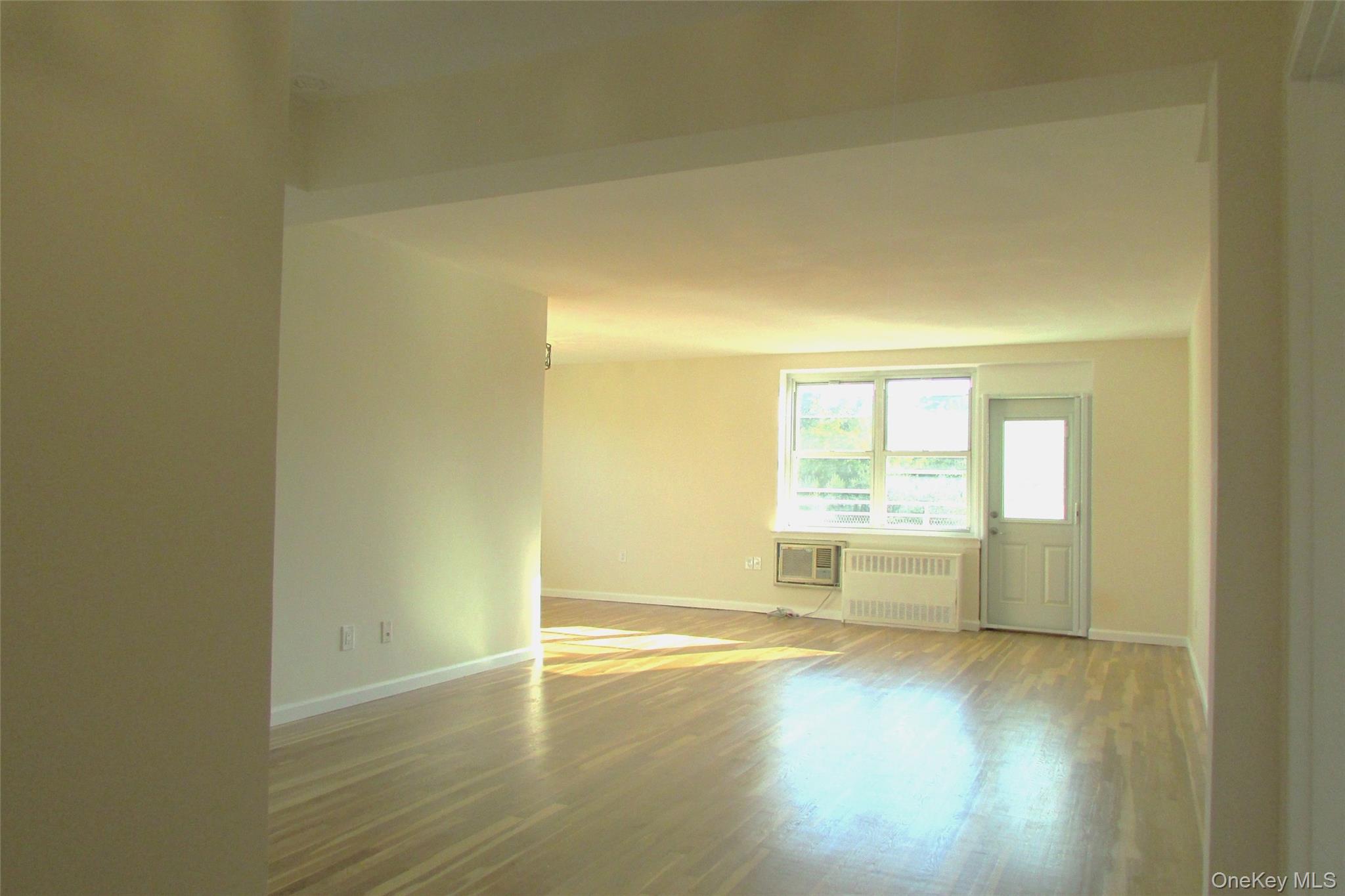 30 South Cole Avenue, Unit 6F Spring Valley, NY 10977 - Photo 6 of 30 an empty room with wooden floor and windows