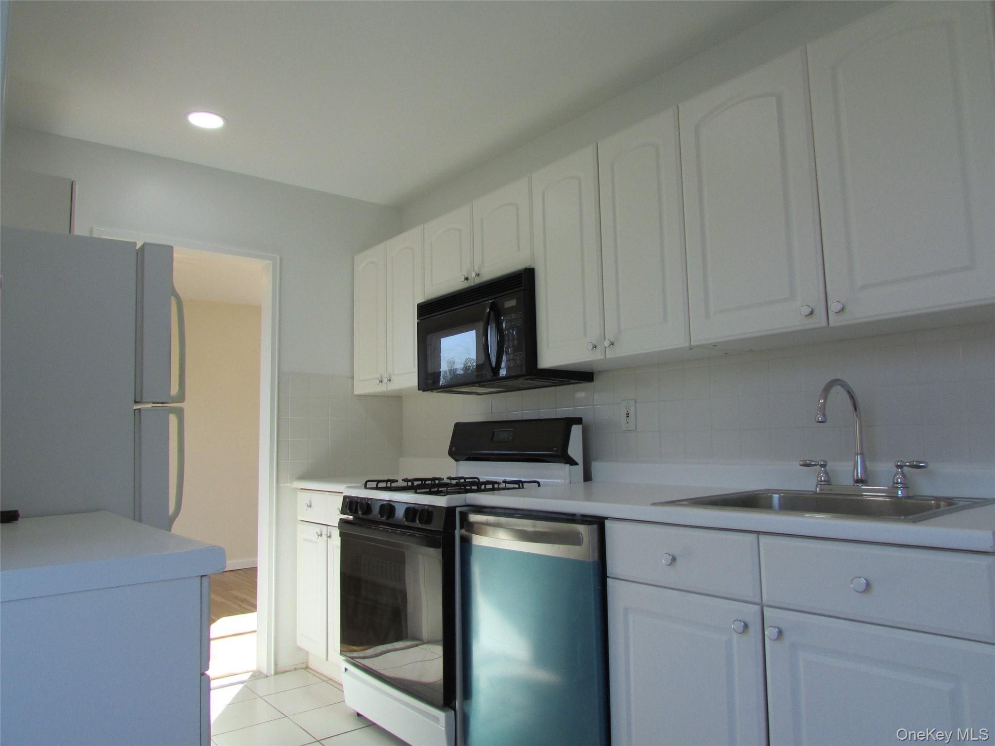 30 South Cole Avenue, Unit 6F Spring Valley, NY 10977 - Photo 10 of 30 a kitchen with a sink and a stove top oven
