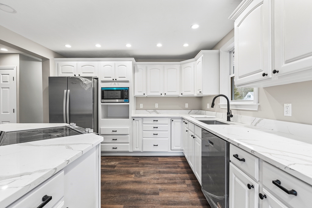 233 Central Street Foxboro, MA 02035 - Photo 3 of 16 a kitchen with a sink stove and refrigerator