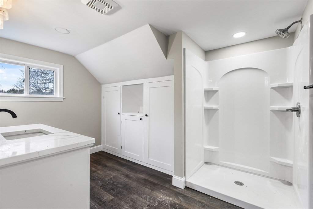 233 Central Street Foxboro, MA 02035 - Photo 9 of 16 a bathroom with a granite countertop sink a mirror and a shower
