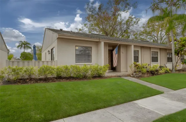 a front view of a house with a garden