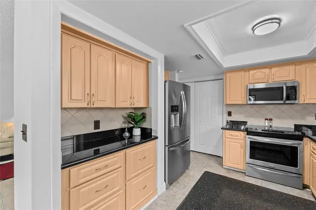 a kitchen with stainless steel appliances a stove a sink and a microwave
