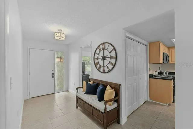 a living room with furniture a clock and a fireplace